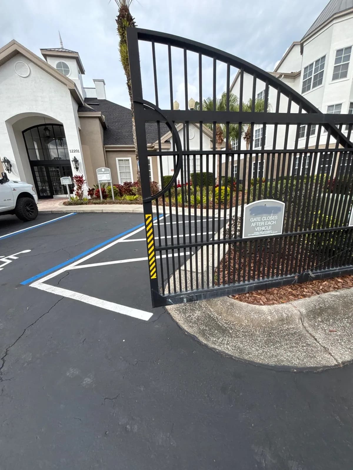Arched swing gate at an apartment community entrance in Tampa, FL