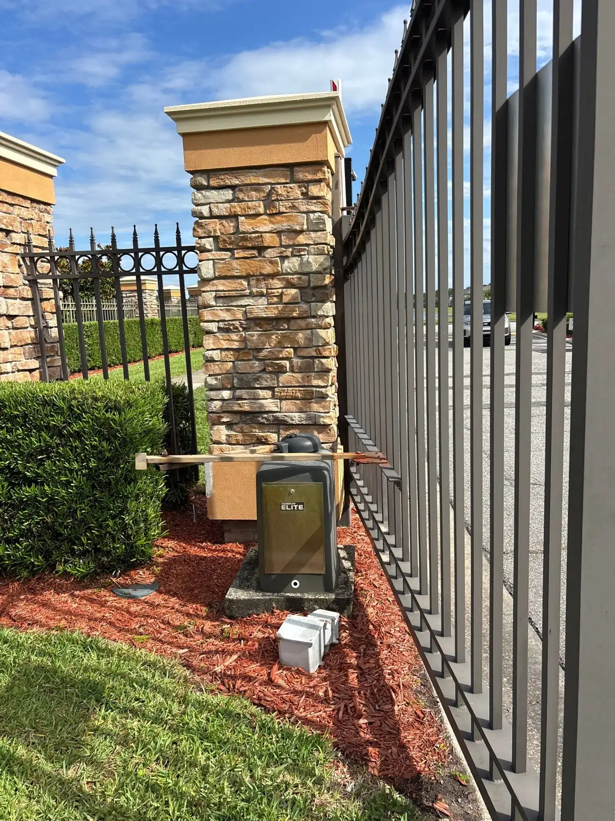 Swing gate hinge side along a brick column in Orlando, FL