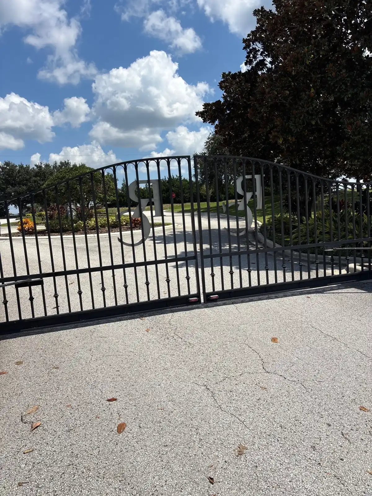 Community entrance swing gate against a blue sky in Groveland, FL