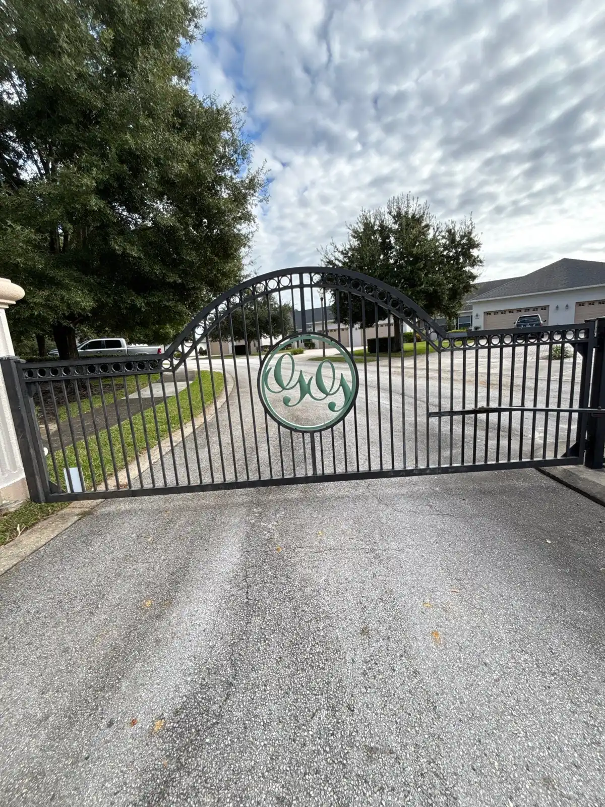 Ornamental swing gate across a community drive in Groveland, FL