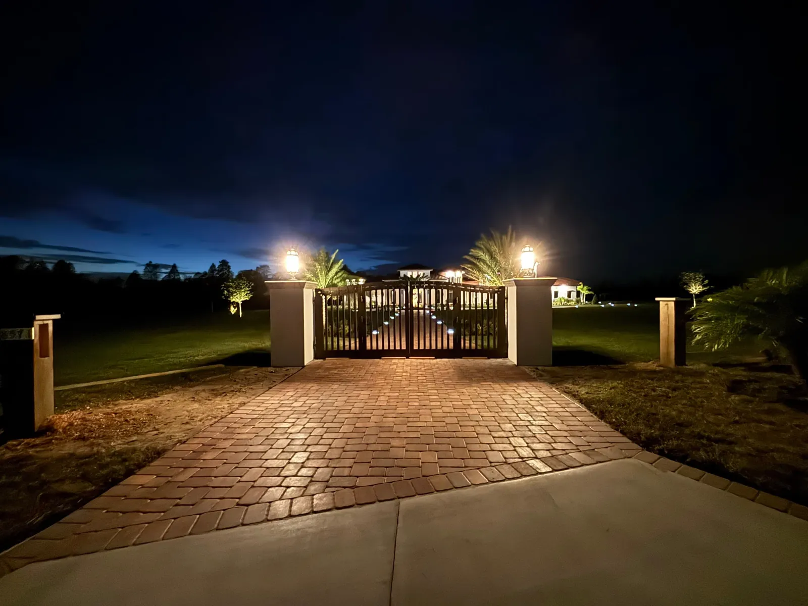 Lit gated estate entrance at night in Clermont, FL