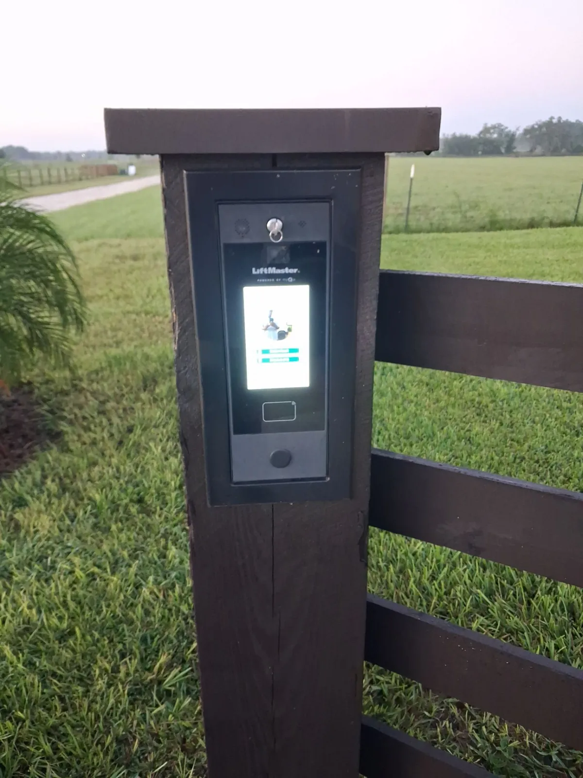 Video intercom mounted on a wood post at a gated entry in Clermont, FL
